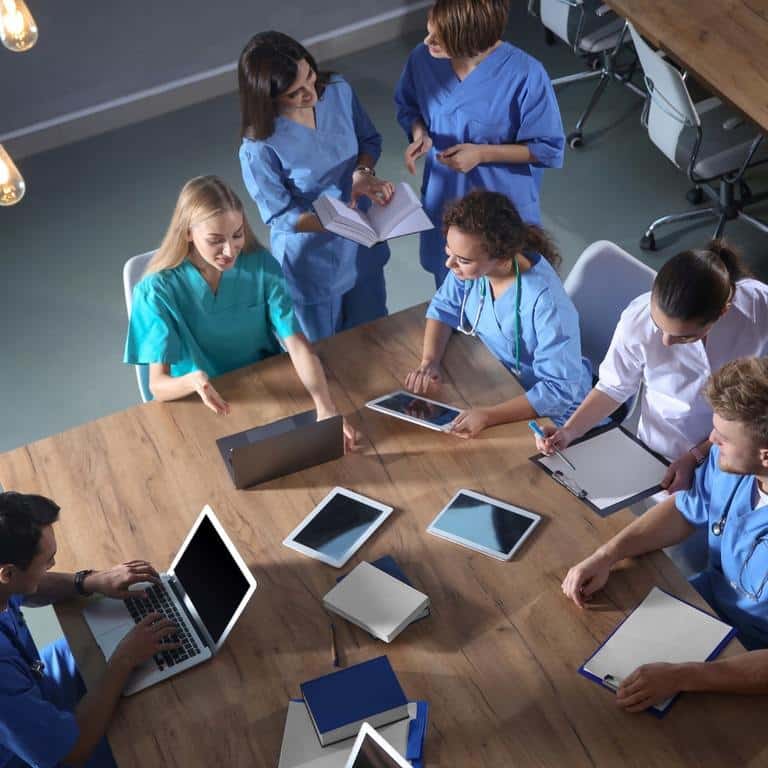 nursing students around table doing research